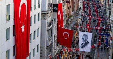 Turkish national flags and a banner depicting Mustafa Kemal Ataturk, the founding father of the Republic of Türkiye, are displayed on Istiklal Avenue, during celebrations to mark the 100th anniversary of the Turkish Republic, in Istanbul, Türkiye, Oct. 29, 2023. (AFP Photo)