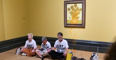 A handout picture from the Just Stop Oil climate campaign group shows three activists sitting on the floor under Vincent Van Gogh's "Sunflowers" in central London, U.K., Sept. 27, 2024. (AFP Photo)