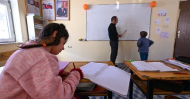Zilan (F) and Barış (R) attend a class at their school in the Gevaş district of Van, eastern Türkiye, Dec. 10, 2024. (AA Photo)