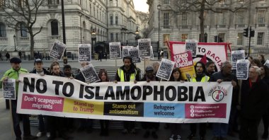 People hold up a banner during a 'Unity Vigil' against racism and Islamophobia in reaction to Wednesday's attack, backdropped by the gates of Downing Street in London, Friday, March 24, 2017. (AP File Photo)