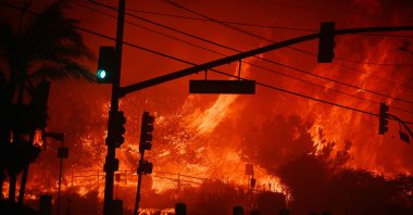 Flames overtake the intersection of Temescal Canyon and the Pacific Coast Highway in Pacific Palisades, California, U.S., Jan. 7, 2025. (AFP Photo)