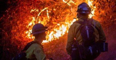 Firefighters watch as the Palisades Fire, one of several simultaneous blazes that have ripped across Los Angeles County, burns in Mandeville Canyon, a neighborhood of Los Angeles, California, U.S., Jan. 12, 2025. (Reuters Photo)