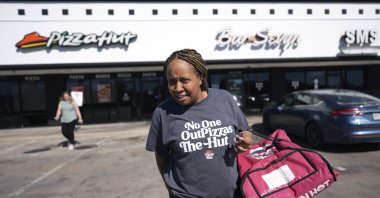 TiAnna Yeldell, a 44-year-old single mom of three, prepares to make a delivery for Pizza Hut in Missouri City, Texas, U.S., Nov. 14, 2024. (AP Photo)