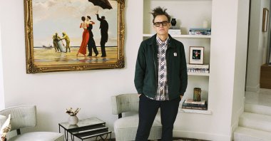 Mark Hoppus of Blink-182 poses by his painting "Crude Oil" ("Vettriano") by Banksy (2005), sold at auction on March 4 with some of the proceeds going to victims of the Los Angeles wildfires. (Sotheby's Handout via AP Photo)