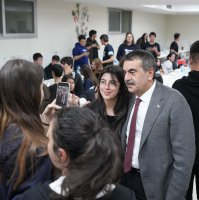 Education Minister Yusuf Tekin poses with a student during an iftar program at a high schoolö Ankara, Türkiye, March 20, 2025. (AA Photo)