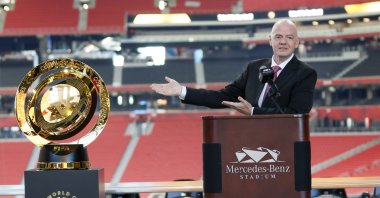 FIFA President Gianni Infantino gestures toward the FIFA World Cup trophy during a news conference at Mercedes-Benz Stadium, Atlanta, U.S., April 14, 2025. (AP Photo)