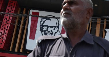 A policeman stands guard outside a KFC outlet, Karachi, Pakistan, April 14, 2025. (EPA Photo)