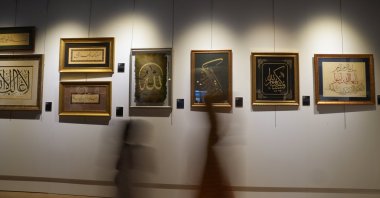 People pass by artworks displayed at the "Loyalty" exhibition at Dolmabahçe Palace, Istanbul, Türkiye, May 7, 2025. (AA Photo)