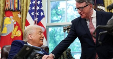 U.S. President Donald Trump (L) shakes hands with Britain's ambassador to the U.S., Peter Mandelson, after announcing a trade deal with the U.K., Washington, D.C., U.S., May 8, 2025. (Reuters Photo)