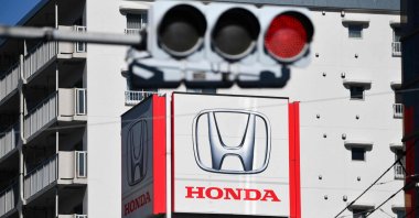 A signboard with the logo of Japanese automaker Honda Motor is seen on the roof of their showroom, Tokyo, Japan, Feb. 6, 2025. (AFP Photo)