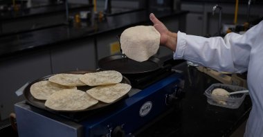 Raquel Gomez Pliego prepares "super tortillas" at the Industrial Microbiology laboratory of the National Autonomous University of Mexico (UNAM), Mexico City, Mexico, April 10, 2025. (AFP Photo)