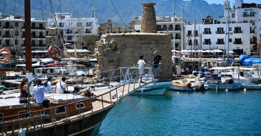 A group of tourists watch the historic Girne Castle from a boat docked at the port of Girne (Kyrenia) on the northern coast of the Turkish Republic of Northern Cyprus (TRNC), May 5, 2025. (AA Photo)