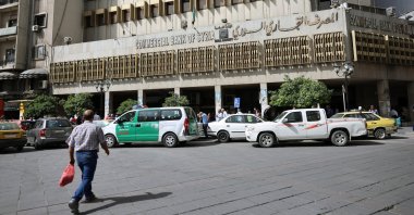 A person walks near the Commercial Bank of Syria building in Damascus, Syria, May 14, 2025. (EPA File Photo)