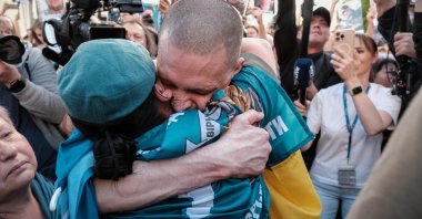A Ukrainian soldier recently released from Russian captivity is reunited with his family on his arrival in Chernigiv Oblast, Ukraine, May 23, 2025. (EPA Photo)