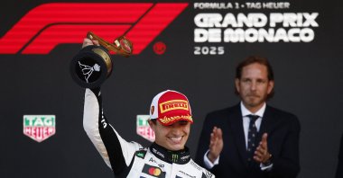 McLaren's Lando Norris celebrates on the podium with a trophy after winning the Monaco Grand Prix at the Circuit de Monaco, Monaco, May 25, 2025. (Reuters Photo)