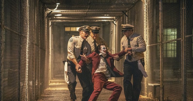 Joaquin Phoenix (foreground C) and Brendan Gleeson (background C) in a scene from "Joker: Folie a Deux." (AP Photo)