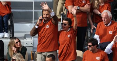 Former French tennis player Henri Leconte waves, next to Jo-Wilfried Tsonga (C, below) during a ceremony honoring Rafael Nadal's career on Court Philippe-Chatrier at the Roland-Garros Complex, Paris, France, May 25, 2025. (AFP Photo)