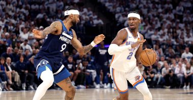Oklahoma City Thunder's Shai Gilgeous-Alexander (R) drives to the basket against Nickeil Alexander-Walker during the third quarter in Game Four of the Western Conference Finals of the 2025 NBA Playoffs, Minneapolis, U.S., May 26, 2025. (AFP Photo)