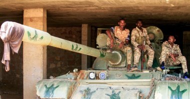 Sudanese army soldiers sit atop a parked tank after their capture of a base used by the rival Rapid Support Forces (RSF) paramilitaries after the latter group evacuated from the Salha area of Omdurman, Sudan, May 26, 2025. (AFP Photo)