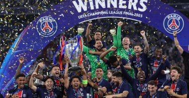 Paris Saint-Germain's Marquinhos lifts the trophy as he celebrates with teammates winning the UEFA Champions League final football match against Inter Milan, Munich, Germany, May 31, 2025. (AFP Photo)