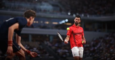 A ball boy passes a ball to Serbia's Novak Djokovic before serving to Austria's Filip Misolic during their men's singles match on day 7 of the French Open tennis tournament on Court Philippe-Chatrier at the Roland-Garros Complex, Paris, France, May 31, 2025. (AFP Photo)