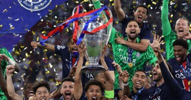 Paris Saint-Germain's Marquinhos lifts the trophy with teammates as they celebrate winning the UEFA Champions League final football match against Inter Milan, Munich, Germany, May 31, 2025. (AFP Photo)