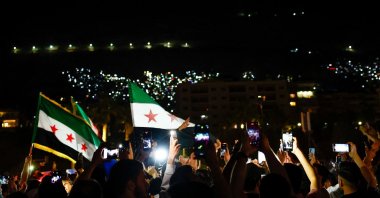 Syrian people celebrate with flags after the lifting of sanctions on Syria, Damascus, Syria, May 13, 2025. (Reuters Photo)