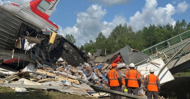 Emergency workers at the scene, after a road bridge collapsed onto railway tracks due to an explosion in the Bryansk region, Russia, June 1, 2025. (Reuters Photo)