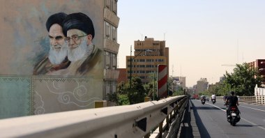 Iranians drive past a wall painting of Iranian supreme leader Ayatollah Ali Khamenei (R) and late Iranian supreme leader Ayatollah Ruhollah Khomeini (L) on a street in Tehran, Iran, June 1, 2025. (EPA Photo)