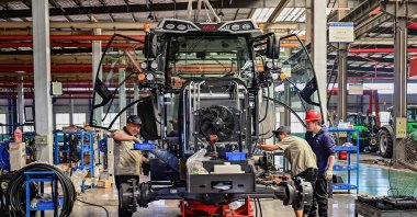 Employees work on a tractor assembly line at a factory, Qingzhou, Shandong province, China, May 27, 2025. (AFP Photo)